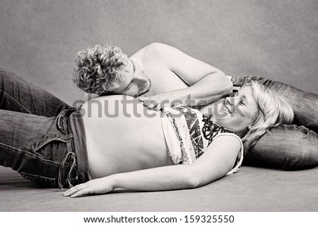 A loving young father laying his head on the swollen belly of his pregnant wife listening to the heart beats of his unborn baby
