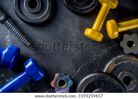 Sport and fitness concept background with dumbbells. Weight Training Equipment. Top view with space for your text, Black marble background.