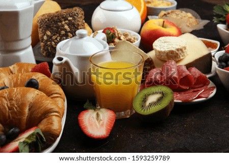 Breakfast served with coffee, orange juice, croissants, cereals and fruits. Balanced diet. Continental breakfast with granola