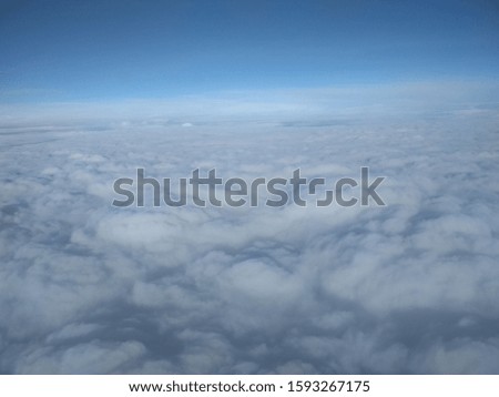 View from airplane window space above the clouds photography blue sky horizon 