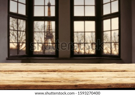 Wooden table background of free space and dark old window sill with city landscape.Copy space and morning time. 