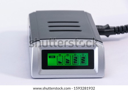 process of charging the battery. Green screen with battery indicator. charger on a white background. close-up.