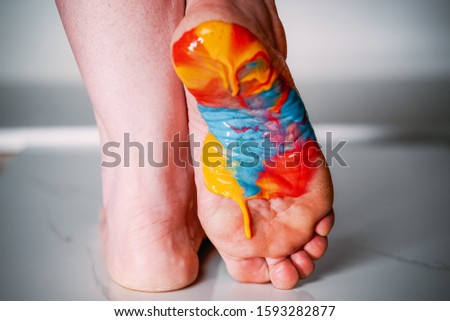 Foot painted with multi-colored acrylic paint