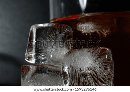 textured ice cubes on the background of a glass with a drink