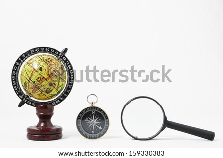 Vintage Tools Globe Compass and Loupe on a White Background
