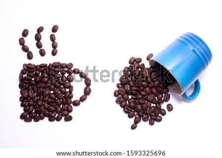Cup of coffee shape created with coffee beans and a cup of spilled coffee beans over a white background