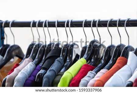 Clothes hanging on hanger in shopping mall.	
