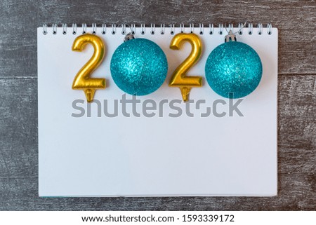 New Year and Christmas frame composition. Blank sheet of paper with christmas decorations on wooden background. Top view, flat lay, copy space. Template design card. Trendy color of the year 2020.