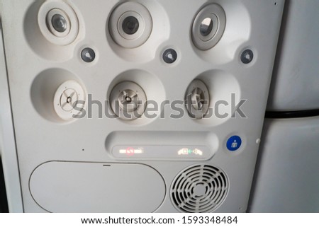 aircraft overhead passenger console incorporating air conditioning vents and lights plus fasten seat belt and no smoking signs illuminated