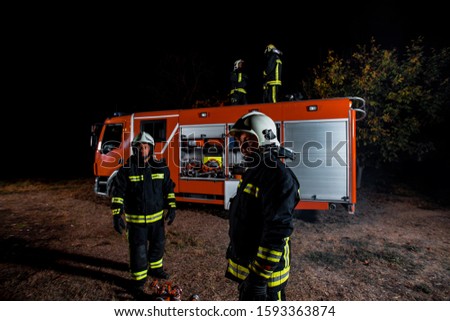 Firemen outfitted with gear during a firefighting operation