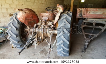 Vintage tractor, country house garage, old style farming