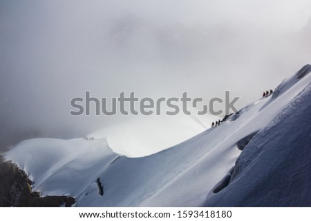 Stock photo of a group of people doing extreme climbing on the top of Mont Blanc