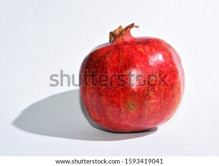 Single Pomegranate isolated with white background.