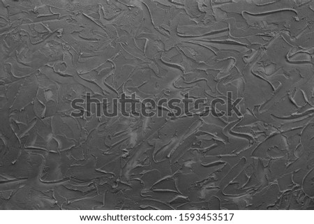 It is a horizontal grey abstract solid background with rough texture. Texture in the form of brush strokes and spatula. Suitable for any design.