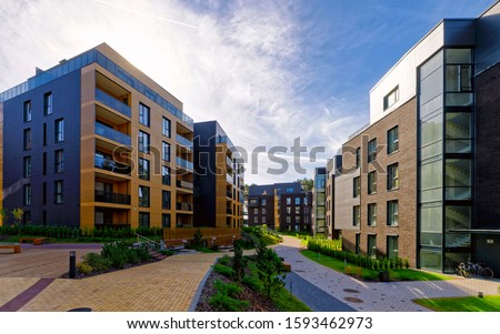 Apartment in residential building exterior. Housing structure at blue modern house of Europe. Rental home in city district on summer. Wall and glass high architecture for business property investment. Royalty-Free Stock Photo #1593462973