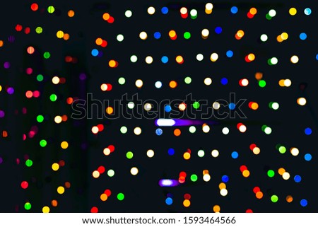 Blurred holiday psychedelic defocused lights yellow, green, red background. String lights, Celebration, new year or christmas concept.