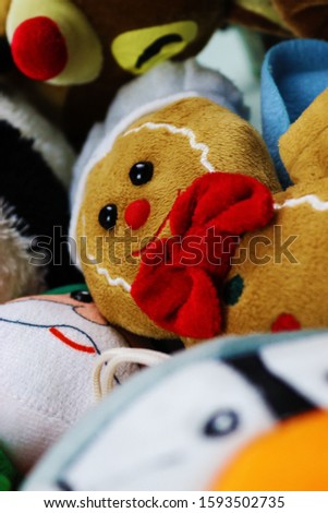 Stuffed gingerbread man with other Christmas toys.