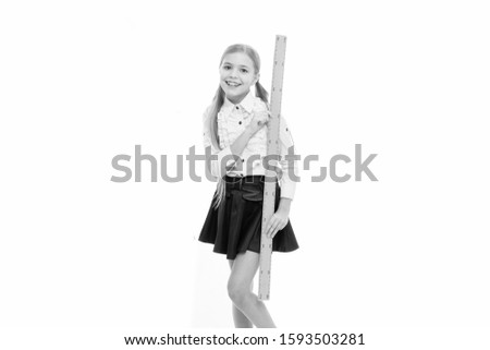 Little girl preparing for geometry lesson. schoolgirl with measuring instrument at school lesson. Small child hold protractor and ruler for lesson. mathematics and people concept.