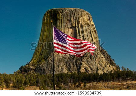 SEPTEMBER 29, 2019, Hulett, Wyoming, USA - US Flag flies over Devils Tower National Monument location for  Close Encounters Motion Picture