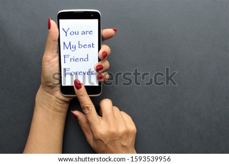 women hands red fingernails typing message sent to her best friend.photo isolate black background copy space