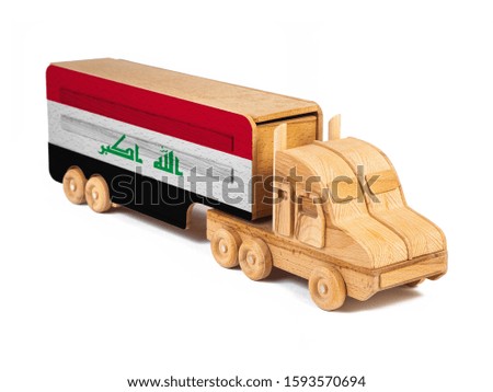Close-up of a wooden toy truck with a painted national flag Irak. The concept of export-import,transportation, national delivery of goods 