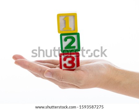 The hand holding 123 blocks. Royalty-Free Stock Photo #1593587275