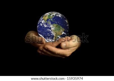 nasa globe in hands on black background
