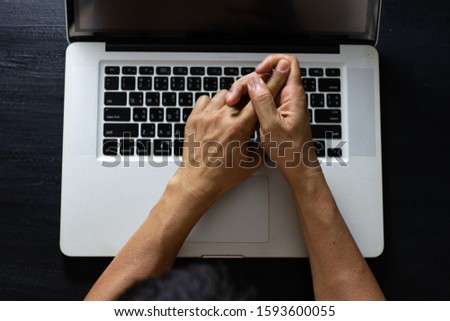 Man working on computer with hand pain, fingers, arm pain