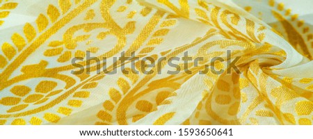 Texture, pattern, collection, silk fabric, women's scarf, golden pastel on a beige background, Printed golden paisley photograph