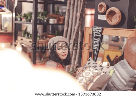 Portrait of young stylish hipster woman visiting antique shops in downtown Portland, winter season