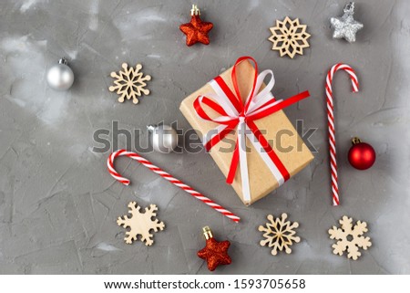 Christmas candy cane red and silver balls stars. New year celebration concept with wooden snowflakes
