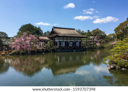 Ancient wooden palace with cherry blossom at Heian Jingu Shrine in Kyoto, Japan.