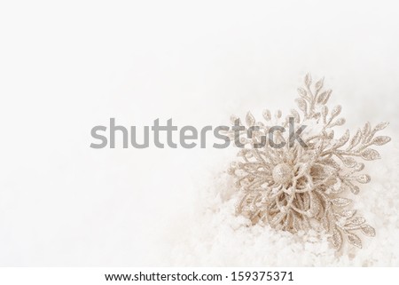 Sparkly Winter or Christmas or New Years Snowflake Ornament in Snow with Background Room or Space for Copy, your Words or Text 