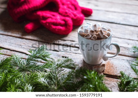 White cup of coffee with marshmallows and cocoa on top on wooden table. Vintage style. Christmas traditional theme