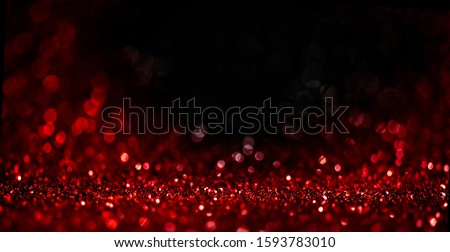 Abstract blur red glitter on black background. Card for Valentine's day, christmas and wedding celebration. Love bokeh sparkle confetti textured layout. Classy elegant design.