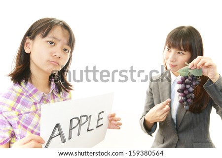 Girl studying in English with teacher 