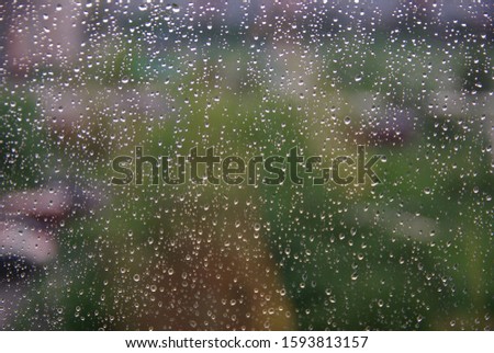 Raindrops on the glass. Blurred background.