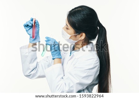 Laboratory science woman checks liquid in a vessel