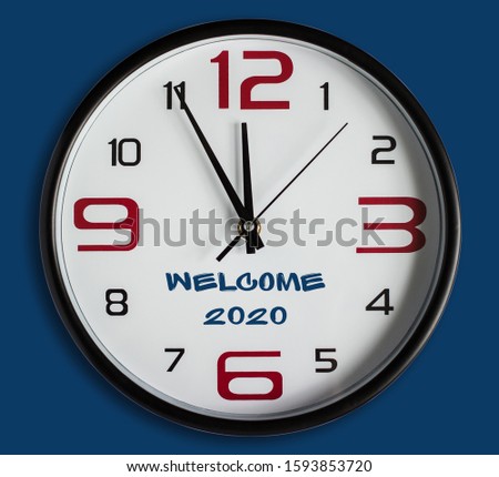 Text WELCOME 2020. Large wall clock on a classic blue background. Merry Christmas and Happy New Year greeting card on blue snow background with copy space. The new color trend of 2020 year