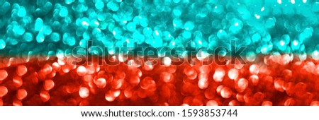 Abstract biscay turquoise green aquamarine and coral red defocused bokeh glitter sparkle confetti burst background. Festive concept. Perfect web banner.