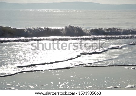 waves hitting beach in the winter daylight 