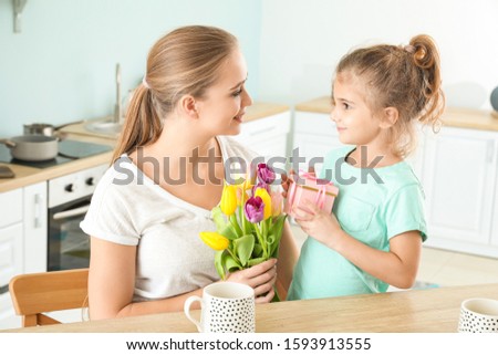 Little girl greeting her mother at home