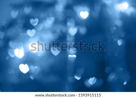 Blur and bokeh abstract background with heart shaped, in style classic blue, color of the year 2020