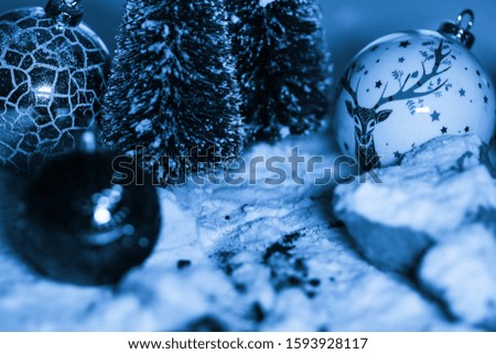 Christmas ball in a winter scenario with snow to reconstruct the Christmas atmosphere, monochromatic image.