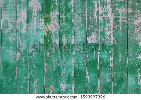 Background of shabby wooden boards of green color. Non-uniform surface in scratches and stains. weathered faded texture. Empty space for text. 