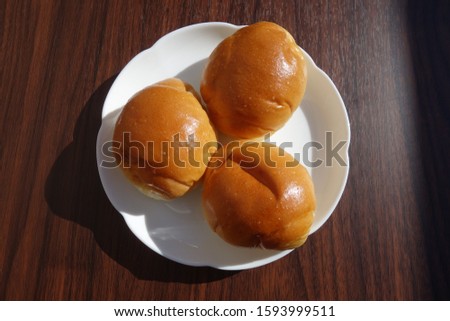 
Butter roll on white plate.