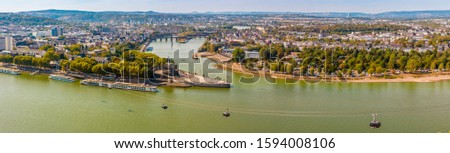 Lovely big aerial panorama picture of the headland "Deutsches Eck" (German Corner) between the Rhine and Mosel rivers, with the Koblenz cableway viewed from the Ehrenbreitstein Fortress in autumn.
