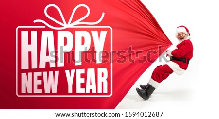 Santa Claus isolated on white studio background. Caucasian male model in traditional costume with biggest giftbag. Concept of Christmas, 2020 New Year's, winter mood. Copyspace, flyer, postcard.