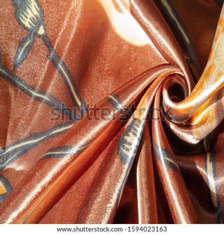Texture, background, pattern, brown silk fabric with floral print, photo taken in bright light,