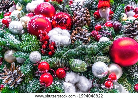 Christmas decoration, artificial Christmas tree. Red and silver glass balls and pine cones, colorful decorations